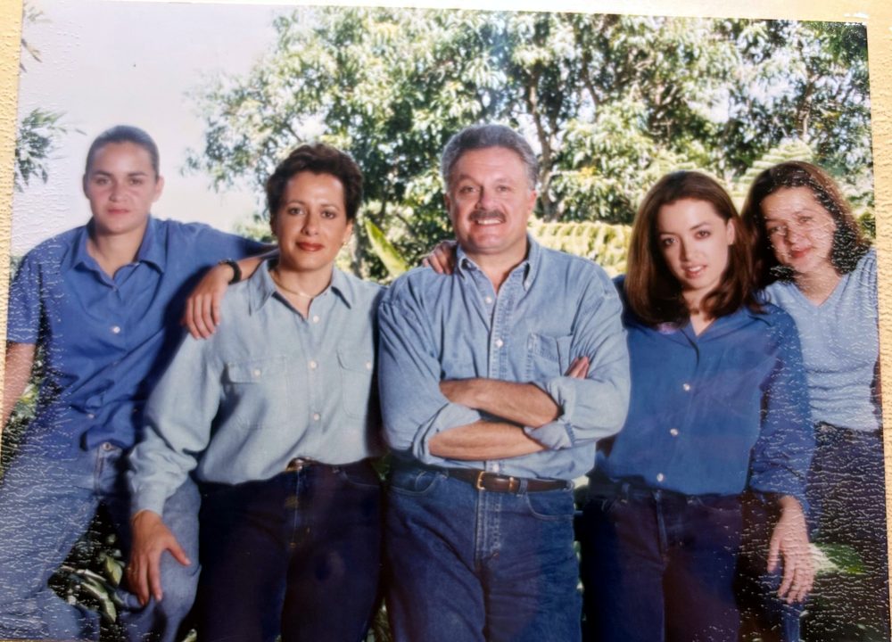The family in matching denim in front of trees