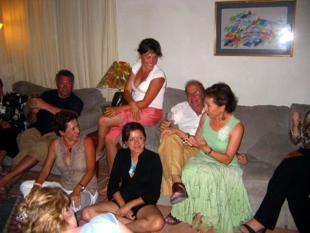 A living room full of family at a party