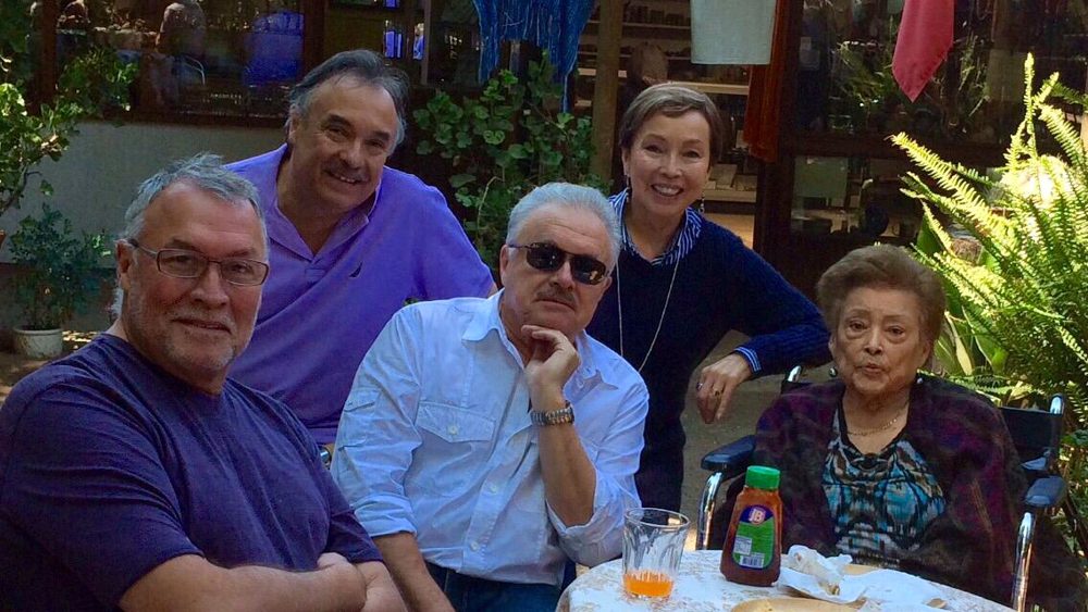 Choco with his siblings and his mother, La Nonna, around a garden table