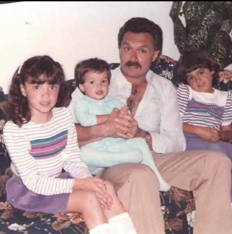 Choco on a sofa with his three young daughters