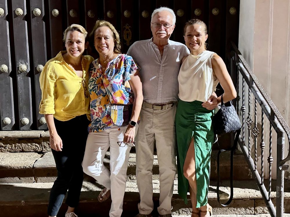 Choco with his wife and two daughters on stone steps at night