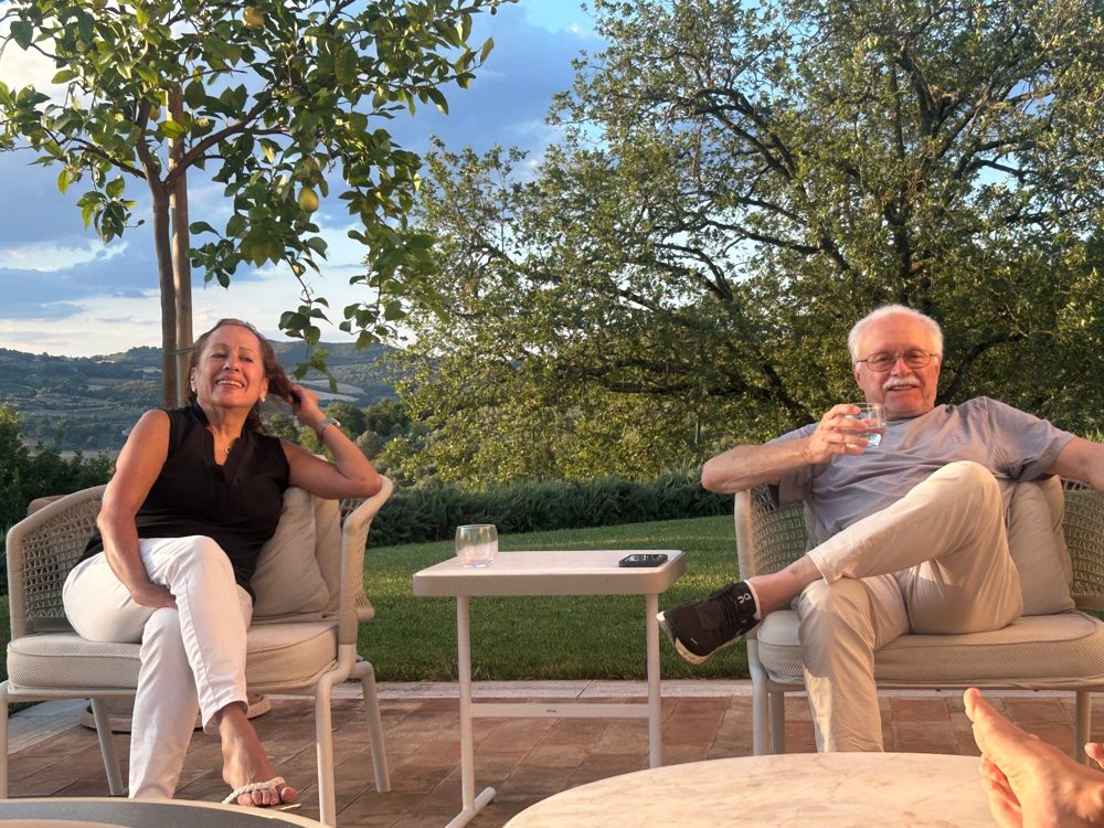 Choco and his wife relaxing on a terrace at golden hour