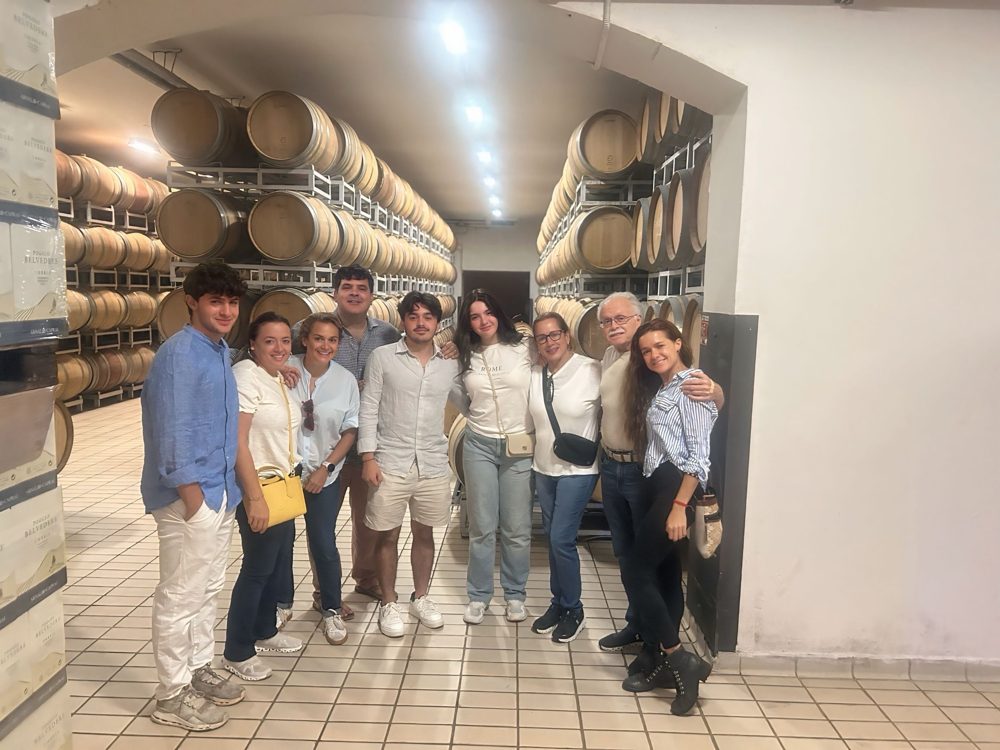 The family in a wine cellar lined with barrels
